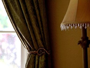 Featured is a photo of an elegant and classic window treatment ... curtains with tiebacks.